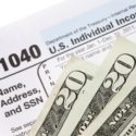 Tax form 1049 with three 20s in front